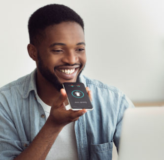 Black Guy Using Smart Phone Voice Assistant Sitting At Home voicemail